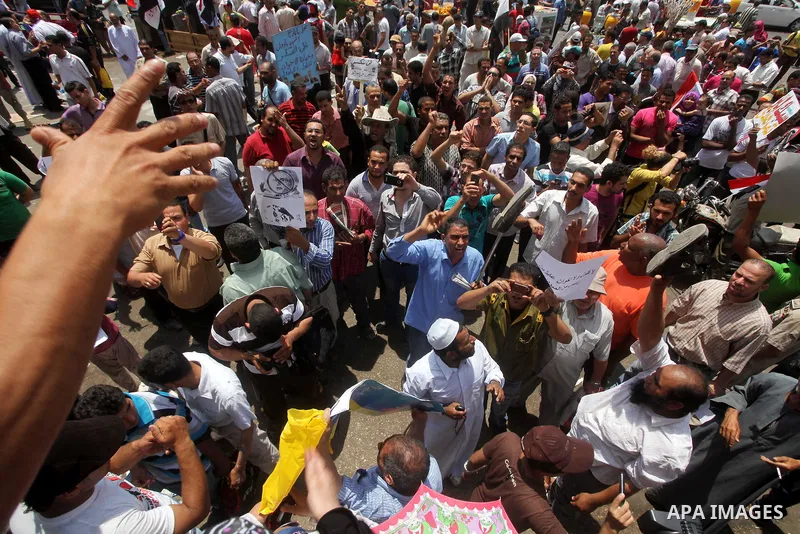 Egyptian protesters hold placards and shout slogans against the presidential candidate Ahmed Shafik, during a protest in Tahrir Square, Cairo, Egypt, 01 June 2012. Media reports state that hundreds of Egyptians held a de...