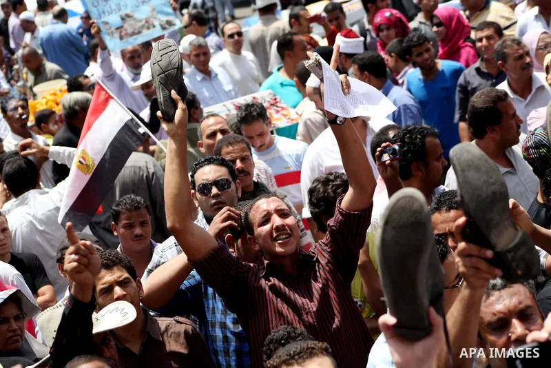 Egyptian protesters hold placards and shout slogans against the presidential candidate Ahmed Shafik, during a protest in Tahrir Square, Cairo, Egypt, 01 June 2012. Media reports state that hundreds of Egyptians held a de...
