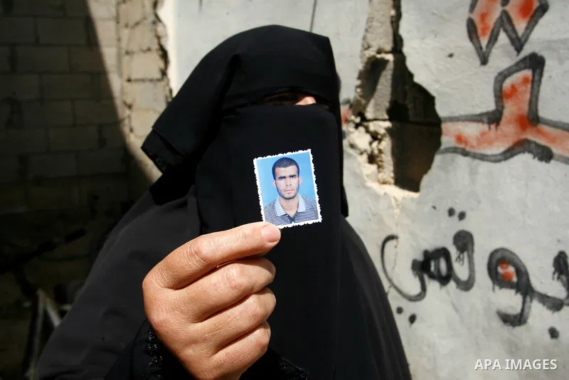 A relative of Ahmed Abu Nasr shows his photograph at his home in Khan Younis Refugee Camp, Friday, June 1, 2012. Abu Nasr and an Israeli soldier were killed in a shootout near the border with the Gaza Strip early Friday,...