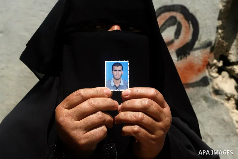 A relative of Ahmed Abu Nasr shows his photograph at his home in Khan Younis Refugee Camp, Friday, June 1, 2012. Abu Nasr and an Israeli soldier were killed in a shootout near the border with the Gaza Strip early Friday,...