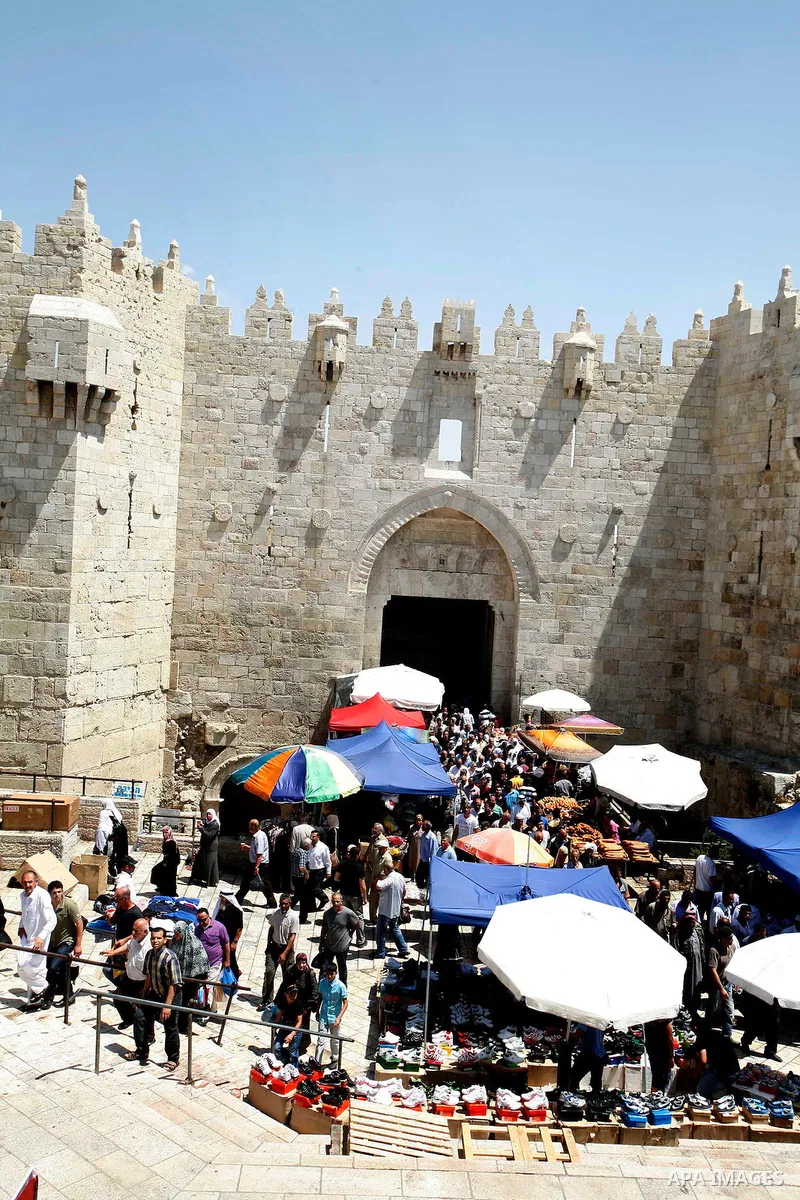 Palestinians hold national flag and shout slogans during a protest against continuing of 'Judaization of Jerusalem' by Jewish settlers and confiscating Palestinian lands at Al Tur and Damascus gate after Friday prayer in...