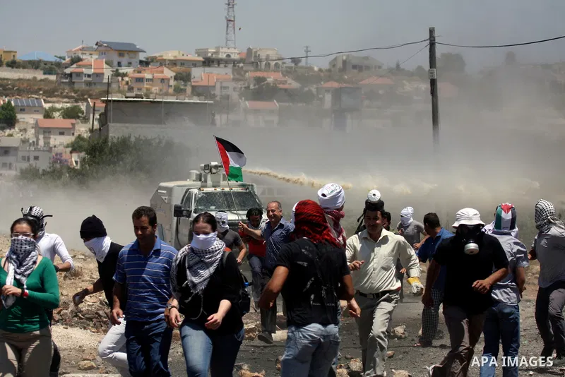 Israeli truck spray foul smelling water towards Palestinian protesters during a demonstration against the expropriation of Palestinian land by Israel in the village of Kafr Qaddum, near the West Bank city of Nablus on Ju...
