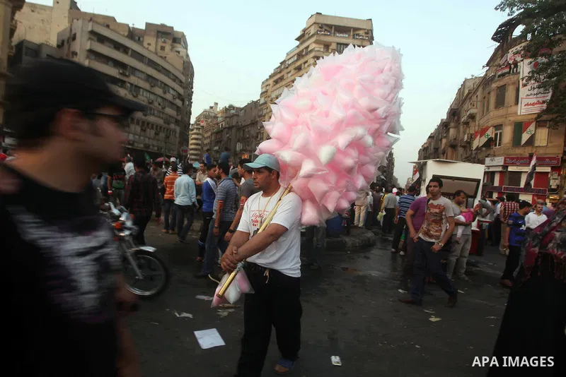 An Egyptian sells sweets during a demonstration against Egyptian presidential candidate Ahmed Shafiq in Tahrir Square decrying the result of the first round of voting in the Egyptian presidential election in Cairo, Egypt...