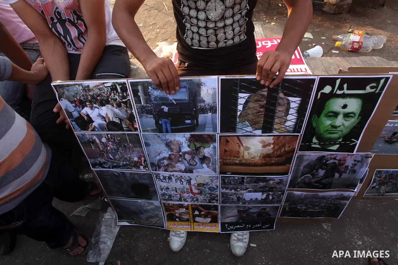 Egyptian protesters hold placards against the presidential candidate Ahmed Shafik during a demonstration in Tahrir Square decrying the result of the first round of voting in the Egyptian presidential election in Cairo, E...