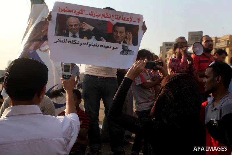 Egyptian protesters hold placards against the presidential candidate Ahmed Shafik during a demonstration in Tahrir Square decrying the result of the first round of voting in the Egyptian presidential election in Cairo, E...