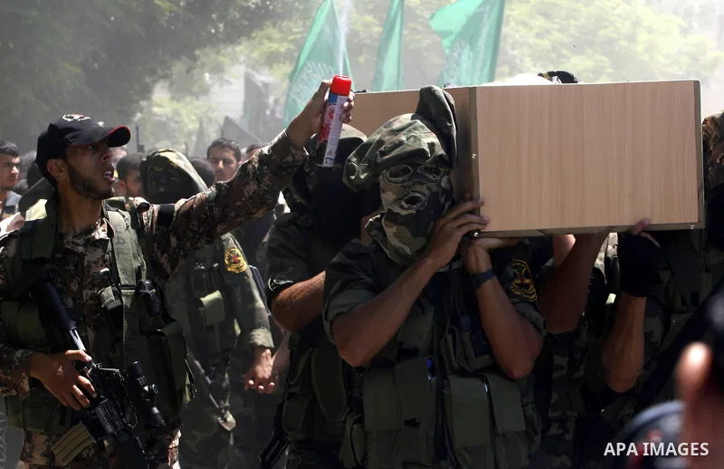 Islamic Jihad militants carry a flag-covered coffin containing the body of gunman Ahmed Nassir in Khan Younis in the southern Gaza Strip June 2, 2012. Nassir broke into Israel on Friday and killed a soldier before being...
