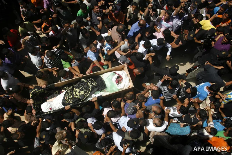 Palestinians carry a flag-covered coffin containing the body of gunman Ahmed Nassir in Khan Younis in the southern Gaza Strip June 2, 2012. Nassir broke into Israel on Friday and killed a soldier before being shot dead h...