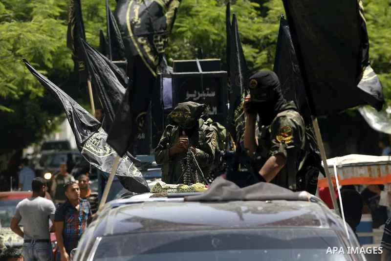 Islamic Jihad militants ride a pick-up truck as they take part in the funeral of Ahmed Nassir in Khan Younis in the southern Gaza Strip June 2, 2012. Palestinian gunman Ahmed Nassir broke into Israel on Friday and killed...