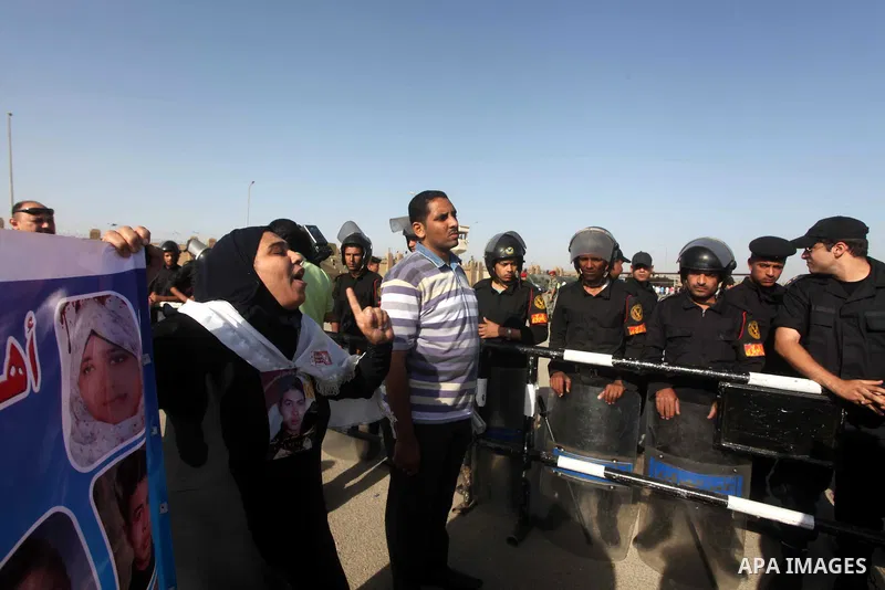 Egyptians Anti-Mubarak protester holding poster depicting youth killed during the uprising, reacts after a court sentenced deposed president Hosni Mubarak to life in prison, outside the police academy in Cairo, Egypt, 02...