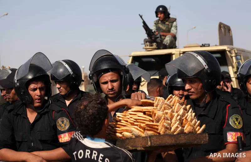 Egyptian riot police stand in front of the courthouse where ex-President Hosni Mubarak received a verdict in his trial for charges related to the death of protesters in Cairo, Egypt, Saturday, May 2, 2012. Egypt's ex-Pre...