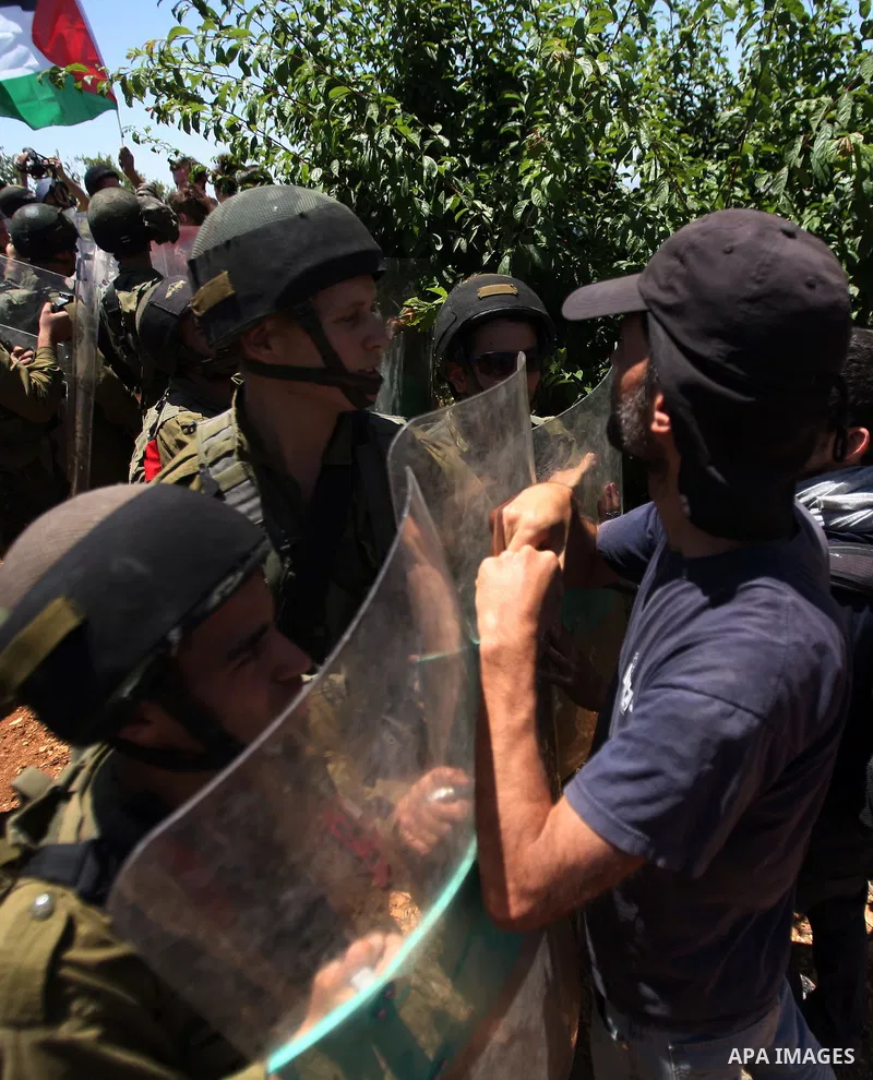Israeli soldiers prevent Palestinians, left-wing Israeli and foreign peace activists from heading towards the Jewish settlement of Karim Tsor to protest against the confiscation of Palestinian land from the West Bank vil...