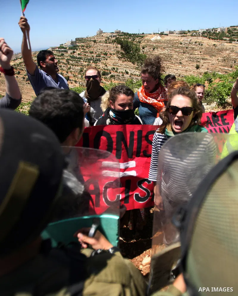 Israeli soldiers prevent Palestinians, left-wing Israeli and foreign peace activists from heading towards the Jewish settlement of Karim Tsor to protest against the confiscation of Palestinian land from the West Bank vil...