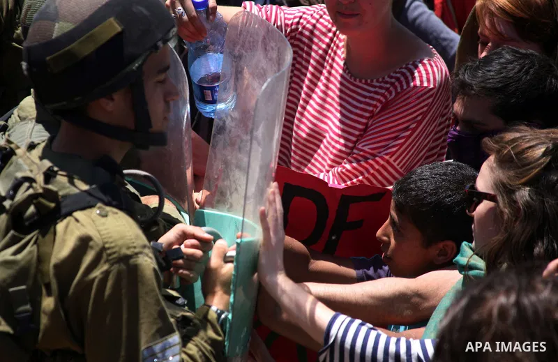 Israeli soldiers prevent Palestinians, left-wing Israeli and foreign peace activists from heading towards the Jewish settlement of Karim Tsor to protest against the confiscation of Palestinian land from the West Bank vil...