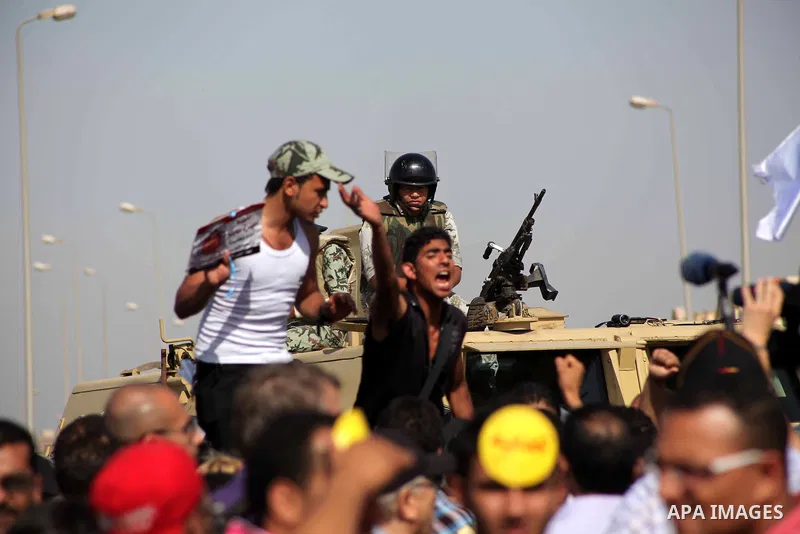 Egyptians Anti-Mubarak protester holding poster depicting youth killed during the uprising, reacts after a court sentenced deposed president Hosni Mubarak to life in prison, outside the police academy in Cairo, Egypt, 02...