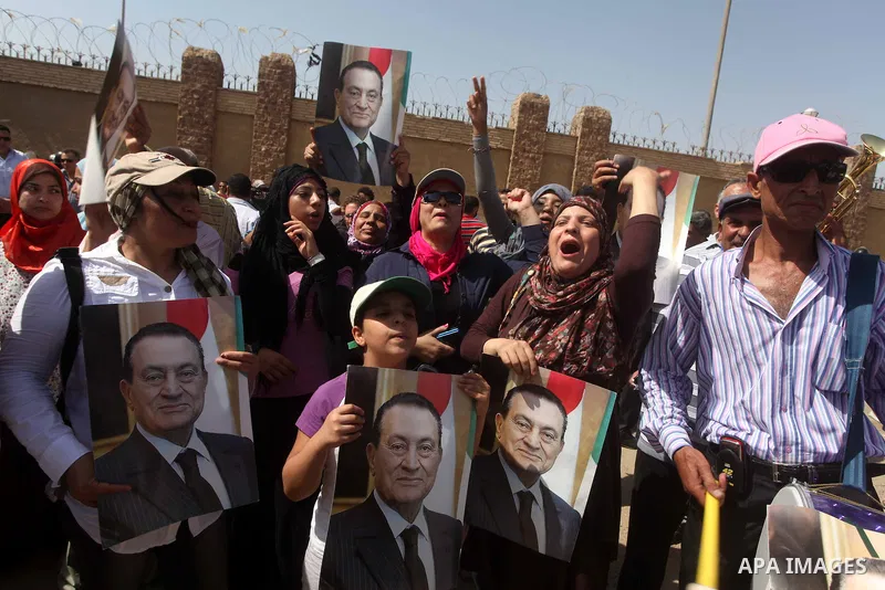 Supporters of deposed president Hosni Mubarak react after a court sentenced him to life in prison, outside the police academy where the court is located in Cairo June 2, 2012. Mubarak was sentenced to life in prison on S...