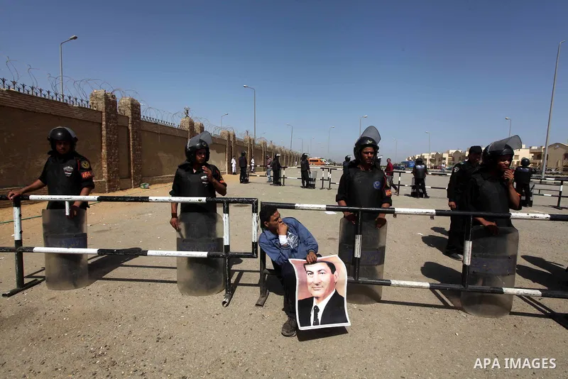 Supporters of deposed president Hosni Mubarak react after a court sentenced him to life in prison, outside the police academy where the court is located in Cairo June 2, 2012. Mubarak was sentenced to life in prison on S...