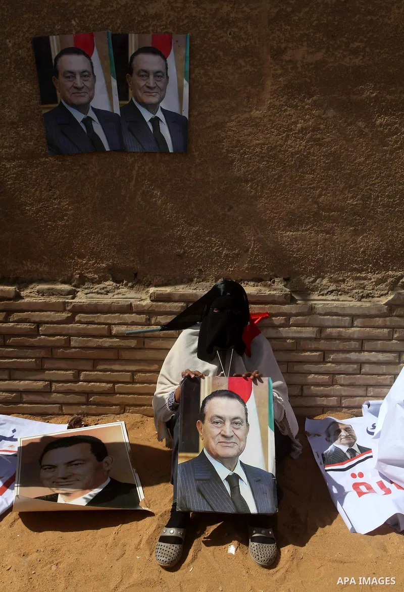 Supporters of deposed president Hosni Mubarak react after a court sentenced him to life in prison, outside the police academy where the court is located in Cairo June 2, 2012. Mubarak was sentenced to life in prison on S...