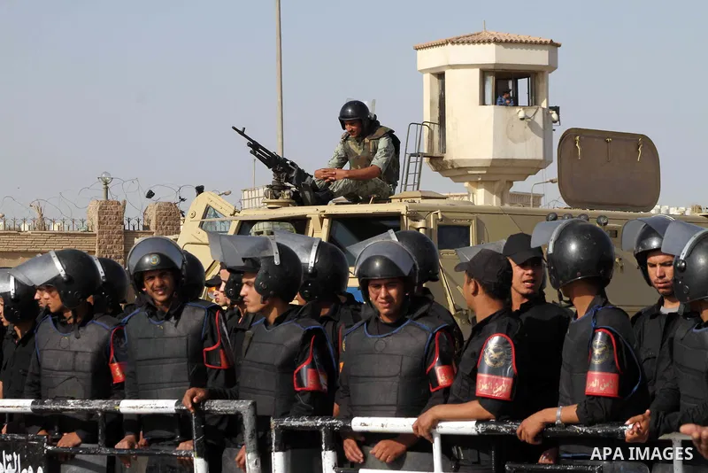 Egyptian riot police stand in front of the courthouse where ex-President Hosni Mubarak received a verdict in his trial for charges related to the death of protesters in Cairo, Egypt, Saturday, May 2, 2012. Egypt's ex-Pre...