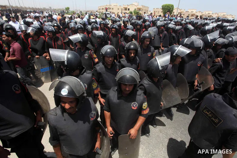 Egyptian riot police stand in front of the courthouse where ex-President Hosni Mubarak received a verdict in his trial for charges related to the death of protesters in Cairo, Egypt, Saturday, May 2, 2012. Egypt's ex-Pre...