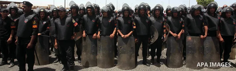 Egyptian riot police stand in front of the courthouse where ex-President Hosni Mubarak received a verdict in his trial for charges related to the death of protesters in Cairo, Egypt, Saturday, May 2, 2012. Egypt's ex-Pre...