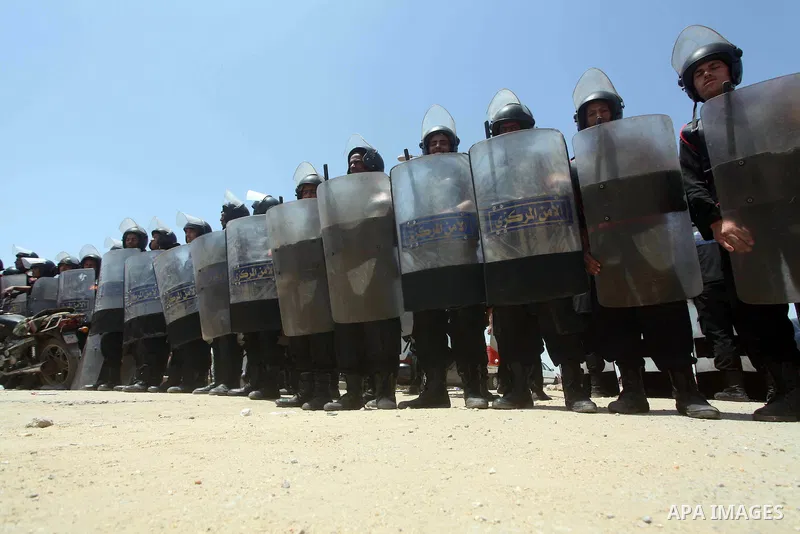 Egyptian riot police stand in front of the courthouse where ex-President Hosni Mubarak received a verdict in his trial for charges related to the death of protesters in Cairo, Egypt, Saturday, May 2, 2012. Egypt's ex-Pre...