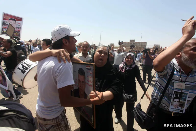 Relatives of people who died during Egypt's revolution react after a court sentenced deposed president Hosni Mubarak to life in prison, outside the police academy where the court is located in Cairo June 2, 2012. Mubarak...