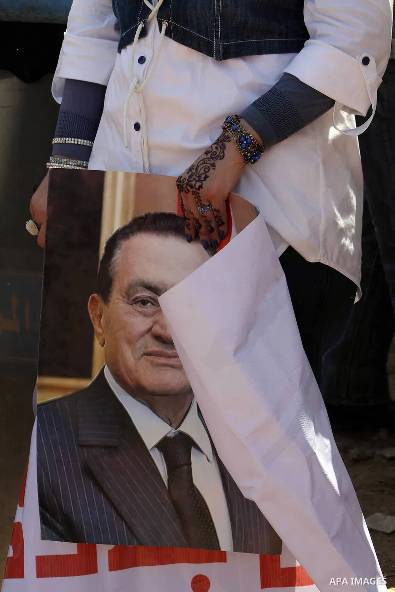Supporters of deposed president Hosni Mubarak react after a court sentenced him to life in prison, outside the police academy where the court is located in Cairo June 2, 2012. Mubarak was sentenced to life in prison on S...