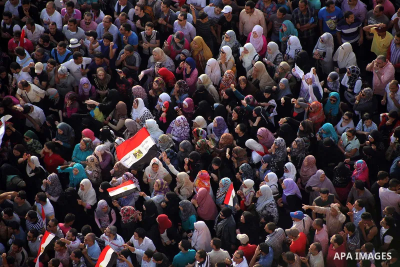 A view taken from a building overviewing Tahrir square shows Egyptian protesters shouting slogans against former President Hosni Mubarak and his aides during a demonstration hours after the announcement of the verdict in...
