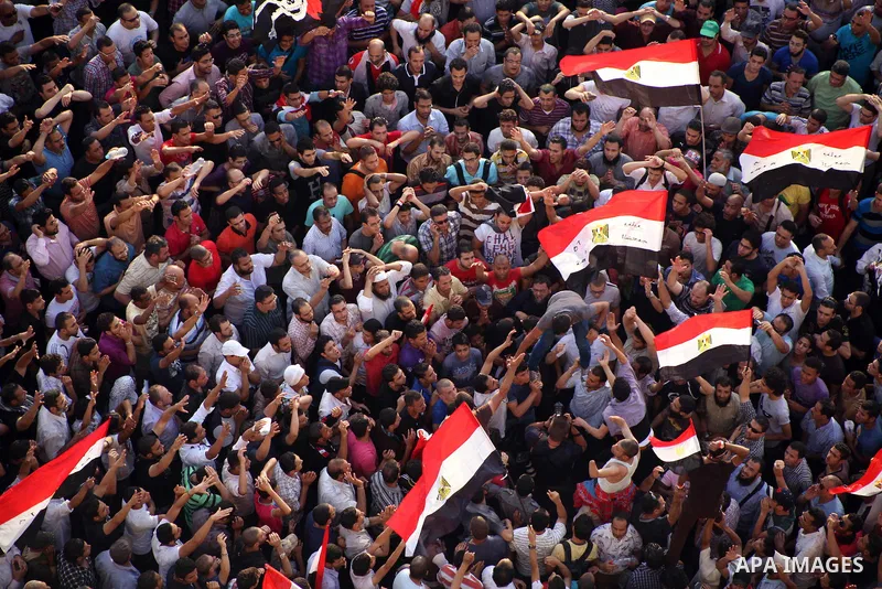 A view taken from a building overviewing Tahrir square shows Egyptian protesters shouting slogans against former President Hosni Mubarak and his aides during a demonstration hours after the announcement of the verdict in...
