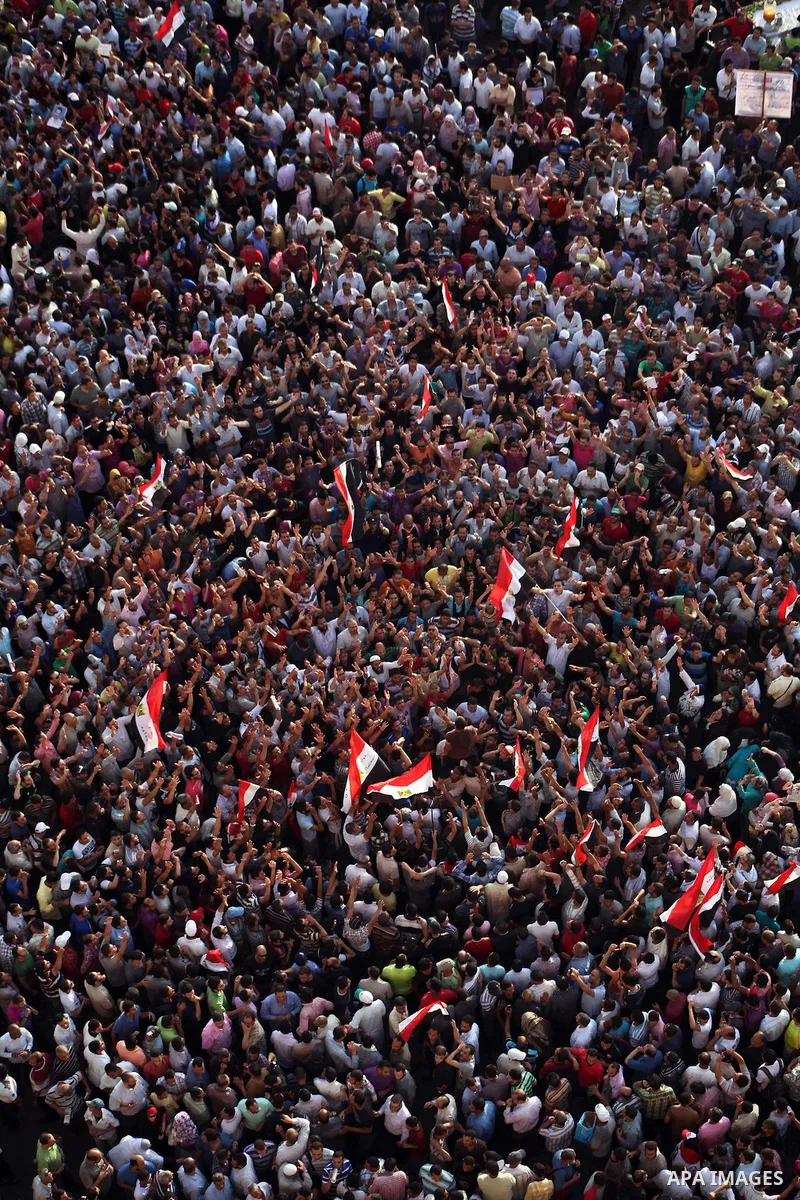 A view taken from a building overviewing Tahrir square shows Egyptian protesters shouting slogans against former President Hosni Mubarak and his aides during a demonstration hours after the announcement of the verdict in...
