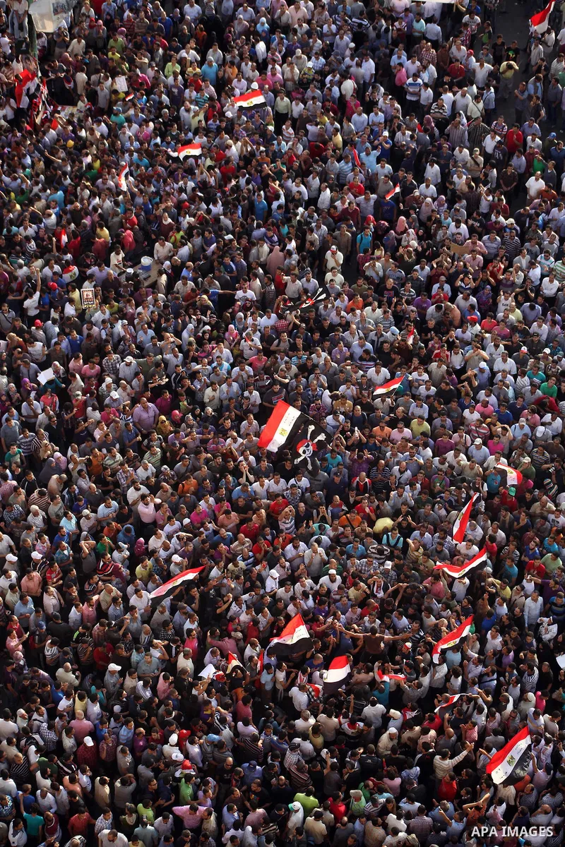 A view taken from a building overviewing Tahrir square shows Egyptian protesters shouting slogans against former President Hosni Mubarak and his aides during a demonstration hours after the announcement of the verdict in...