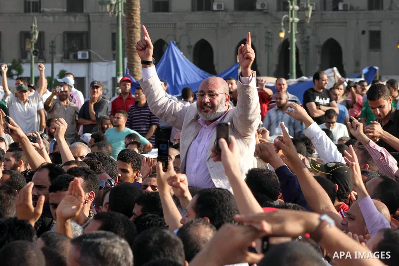 Egyptian preacher and member of the Muslim Brotherhood Safwat el-Hegazy is carried up by protesters as he joins them in a protest, hours after the announcement of the verdict in the trial of the former president Hosni Mu...