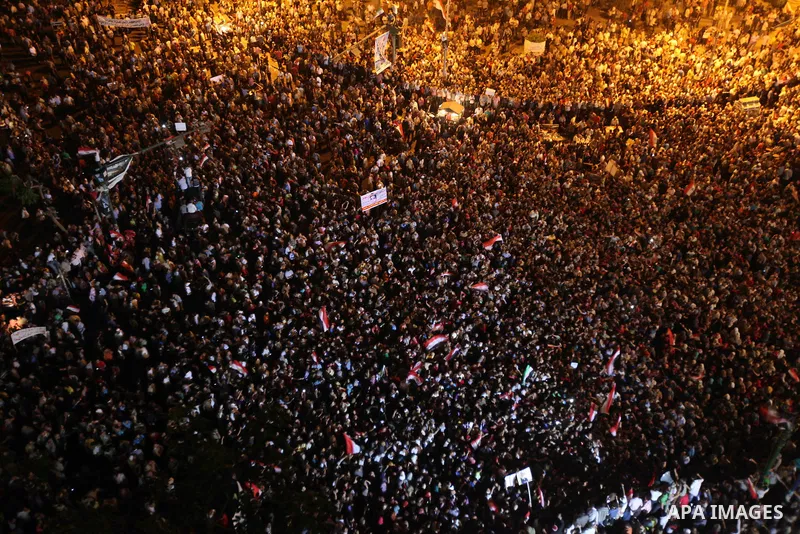 A view taken from a building over viewing Tahrir square shows Egyptian protesters shouting slogans against former President Hosni Mubarak and his aides during a demonstration hours after the announcement of the verdict i...