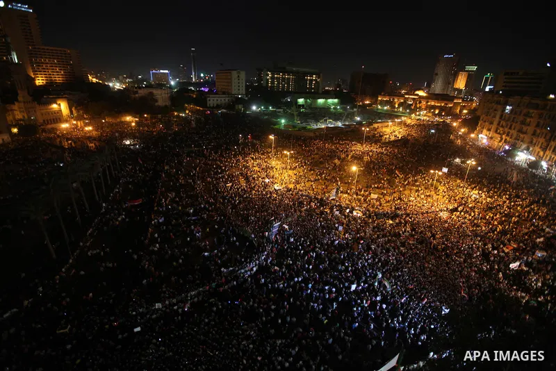 A view taken from a building over viewing Tahrir square shows Egyptian protesters shouting slogans against former President Hosni Mubarak and his aides during a demonstration hours after the announcement of the verdict i...