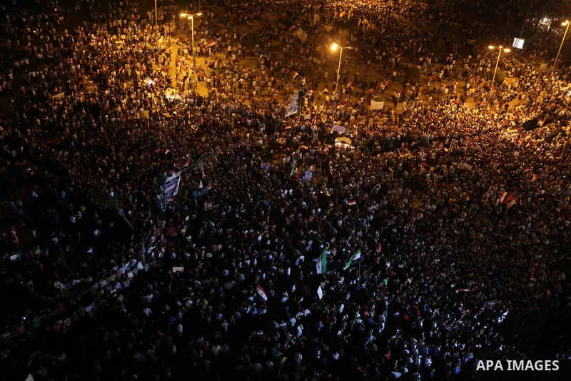 A view taken from a building over viewing Tahrir square shows Egyptian protesters shouting slogans against former President Hosni Mubarak and his aides during a demonstration hours after the announcement of the verdict i...