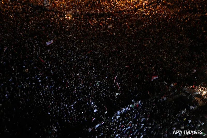 A view taken from a building over viewing Tahrir square shows Egyptian protesters shouting slogans against former President Hosni Mubarak and his aides during a demonstration hours after the announcement of the verdict i...