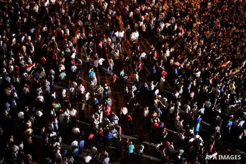 A view taken from a building over viewing Tahrir square shows Egyptian protesters shouting slogans against former President Hosni Mubarak and his aides during a demonstration hours after the announcement of the verdict i...