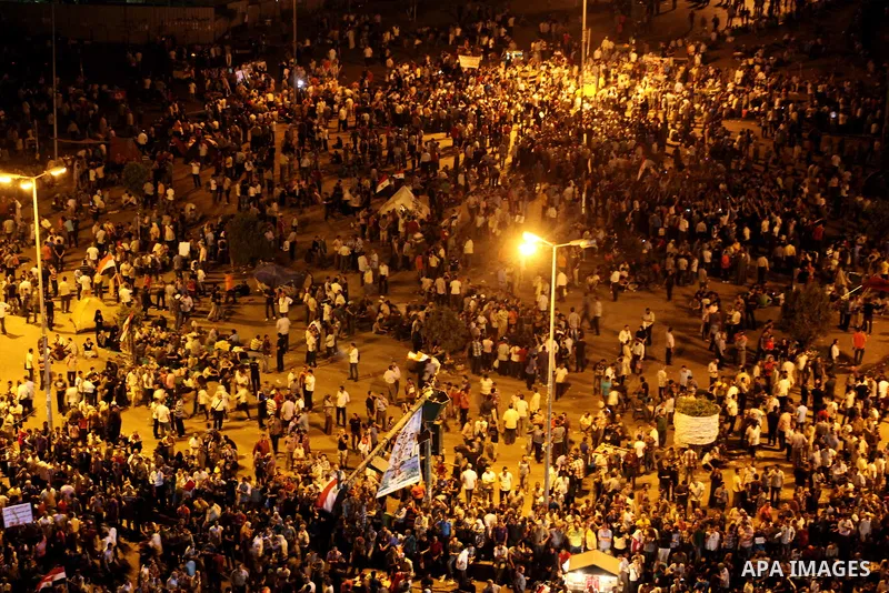 A view taken from a building over viewing Tahrir square shows Egyptian protesters shouting slogans against former President Hosni Mubarak and his aides during a demonstration hours after the announcement of the verdict i...