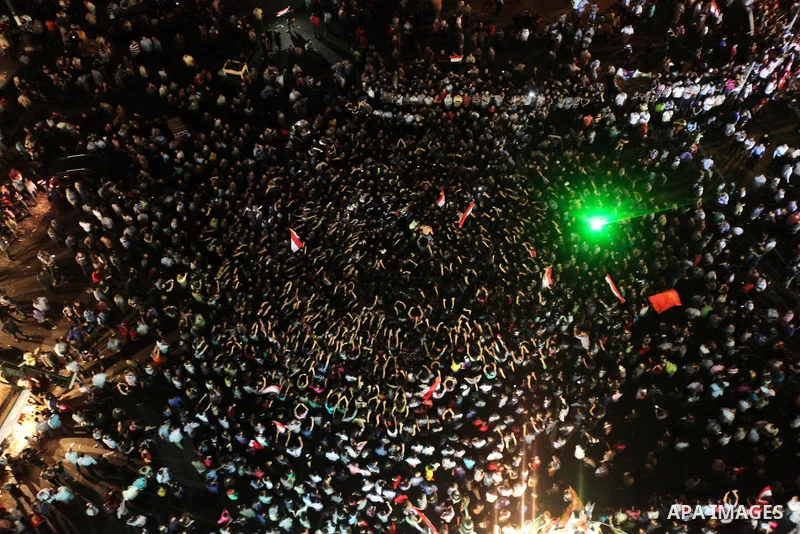 A view taken from a building over viewing Tahrir square shows Egyptian protesters shouting slogans against former President Hosni Mubarak and his aides during a demonstration hours after the announcement of the verdict i...
