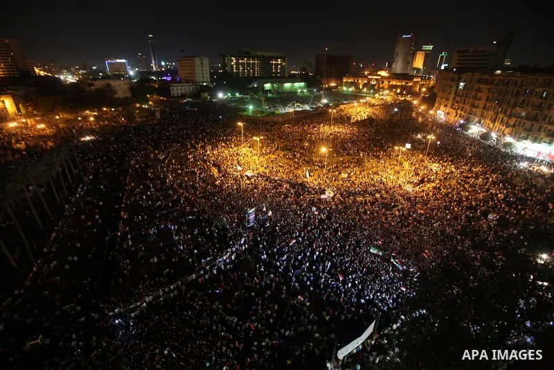 A view taken from a building over viewing Tahrir square shows Egyptian protesters shouting slogans against former President Hosni Mubarak and his aides during a demonstration hours after the announcement of the verdict i...