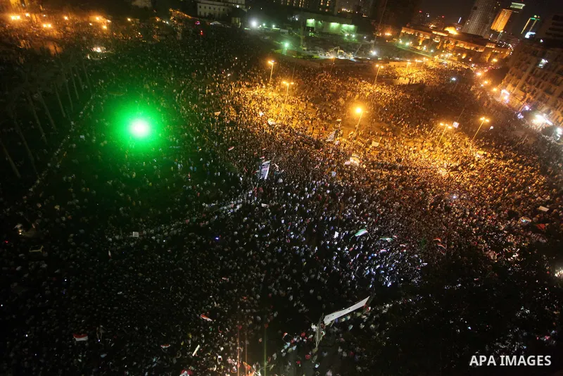 A view taken from a building over viewing Tahrir square shows Egyptian protesters shouting slogans against former President Hosni Mubarak and his aides during a demonstration hours after the announcement of the verdict i...