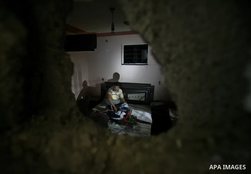 A Palestinian man inspects a destroyed house after an Israeli missile strike in Al-Nussirat Refugee Camp in central Gaza Strip, 03 June 2012. According to news reports, seven Palestinians were wounded in a series of Isra...
