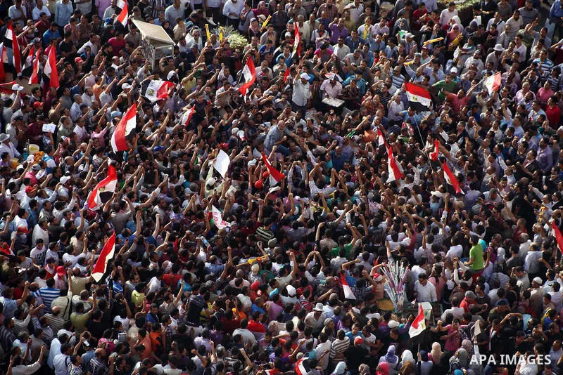 Egyptian preacher and member of the Muslim Brotherhood Safwat el-Hegazy is carried up by protesters as he joins them in a demonstration a day after a court sentenced deposed president Hosni Mubarak to life in prison, at...