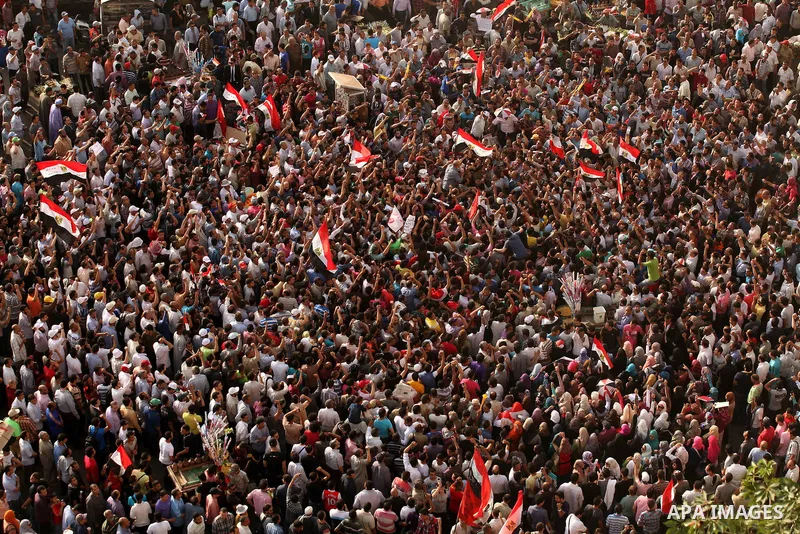 Egyptian preacher and member of the Muslim Brotherhood Safwat el-Hegazy is carried up by protesters as he joins them in a demonstration a day after a court sentenced deposed president Hosni Mubarak to life in prison, at...