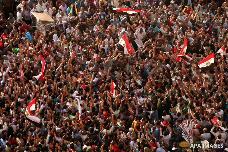 Egyptian preacher and member of the Muslim Brotherhood Safwat el-Hegazy is carried up by protesters as he joins them in a demonstration a day after a court sentenced deposed president Hosni Mubarak to life in prison, at...