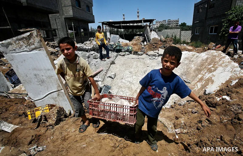 Palestinian boys inspect the damage at a cheese factory in Gaza City on June 4, 2012 following an Israeli air strike on the Gaza Strip on June 3. Emergency medical sources in Gaza said seven Palestinians were wounded in...