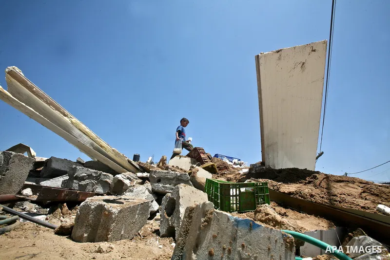 Palestinian boys inspect the damage at a cheese factory in Gaza City on June 4, 2012 following an Israeli air strike on the Gaza Strip on June 3. Emergency medical sources in Gaza said seven Palestinians were wounded in...