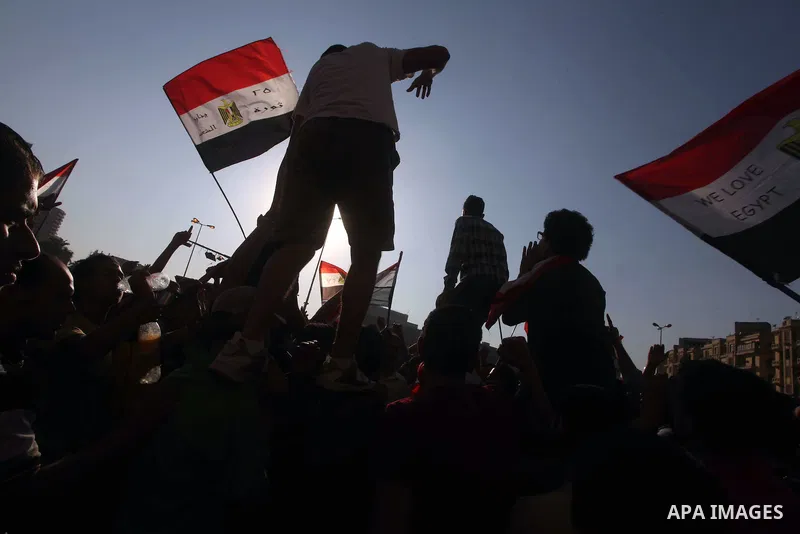 Protesters wave Egypt's flags during a demonstration at Tahrir square in Cairo, against the verdict for deposed leader Hosni Mubarak June 4, 2012. Egyptian pro-democracy campaigners called on Sunday for a new uprising, s...