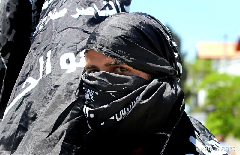 A Palestinian boy, wearing a headband supporting al-Naser Salah ad-Din Brigades, looks out during a rally in Gaza City marking the anniversary of the 1967 Middle East War June 5, 2012. Photo by Yasser Qudeh