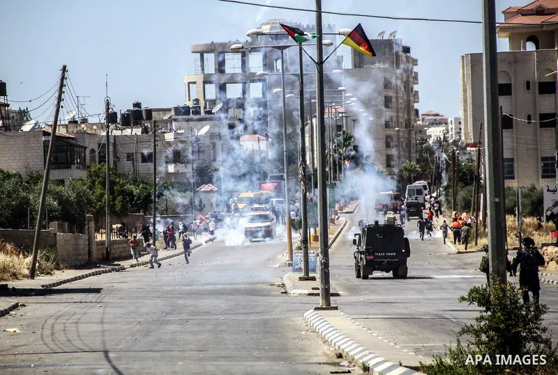 Israeli Soldiers fire tear gas toward Palestinian demonstrators during clashes at the entrance to Ofer prison, near the West Bank city of Ramallah, on June 5, 2012 following a demonstration to mark "Naksa Day", the 44th...
